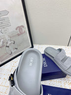 Dior slide sandal with light gray footbed showing 'Dior' lettering