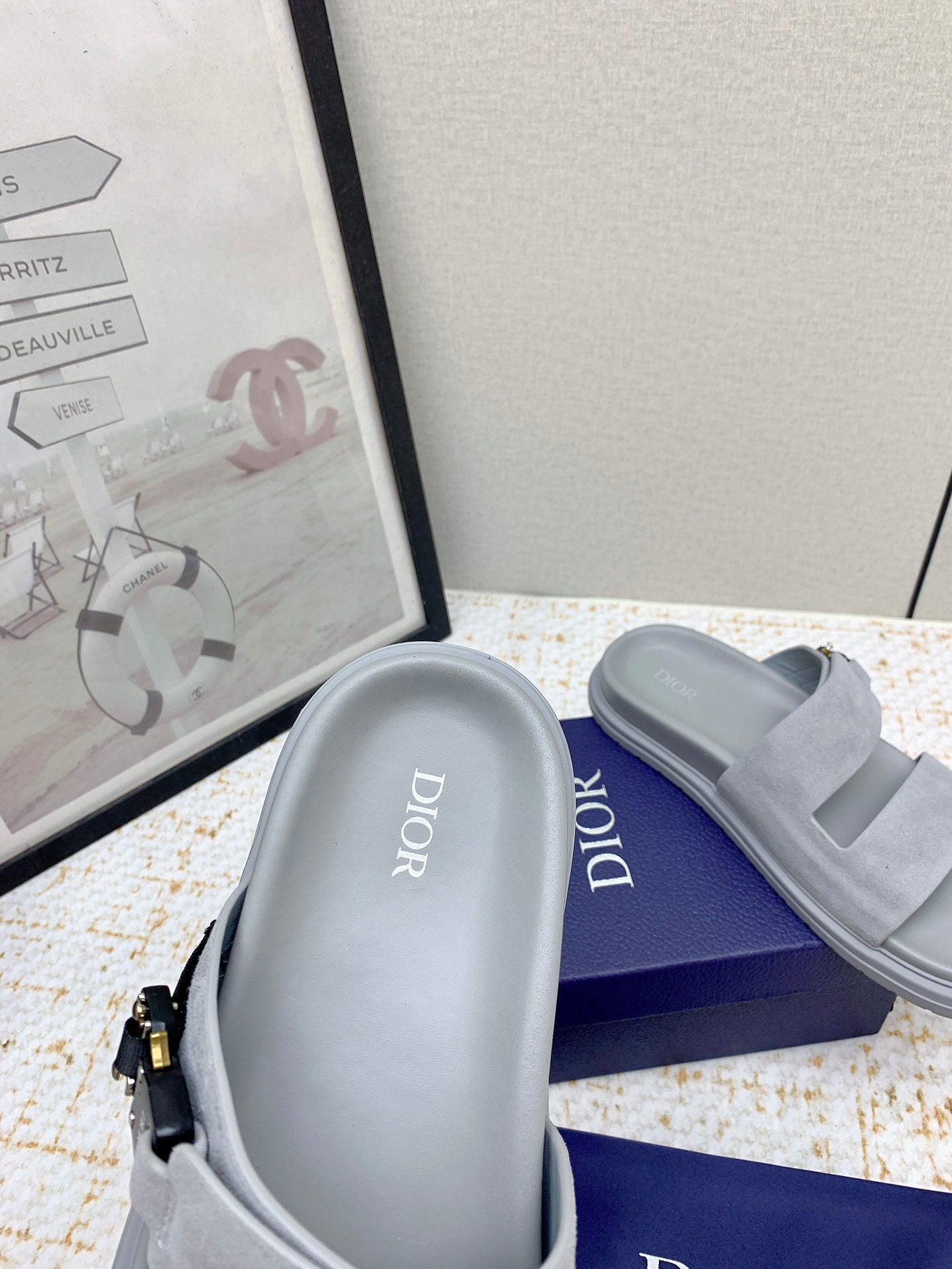 Dior slide sandal with light gray footbed showing 'Dior' lettering