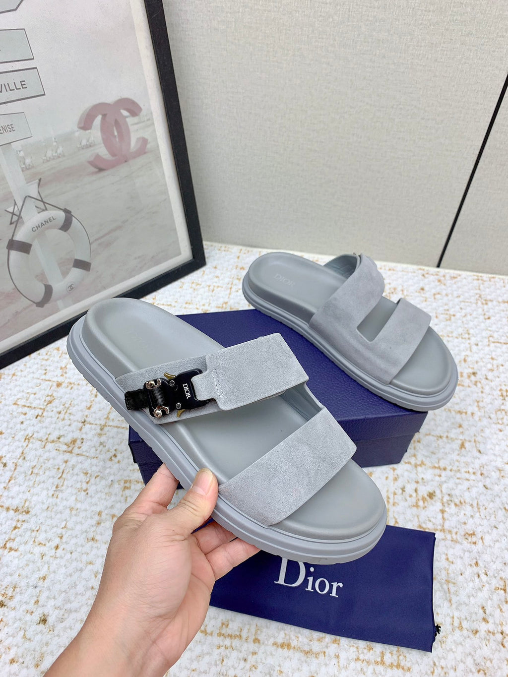 Dior slide sandals in light gray suede, front strap with black buckle and metal accents