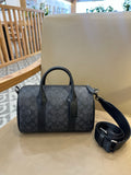 Coah bag with dark patterned exterior, top handles, and detachable crossbody strap