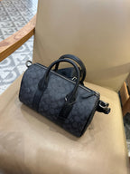 Coah bag with dark patterned exterior, zip front pocket, and crossbody strap