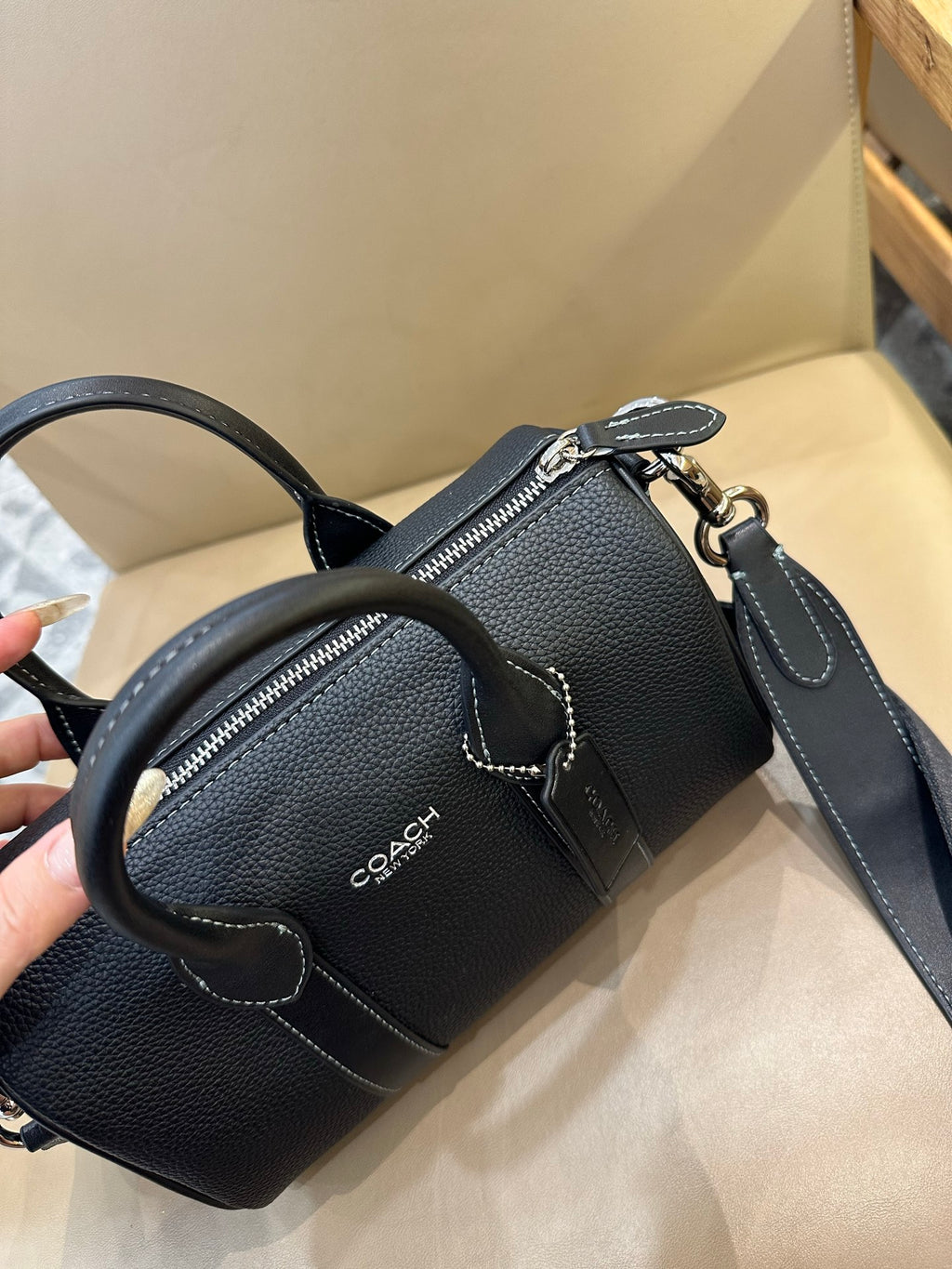 Coach leather mini duffle bag with two zip pockets and crossbody strap