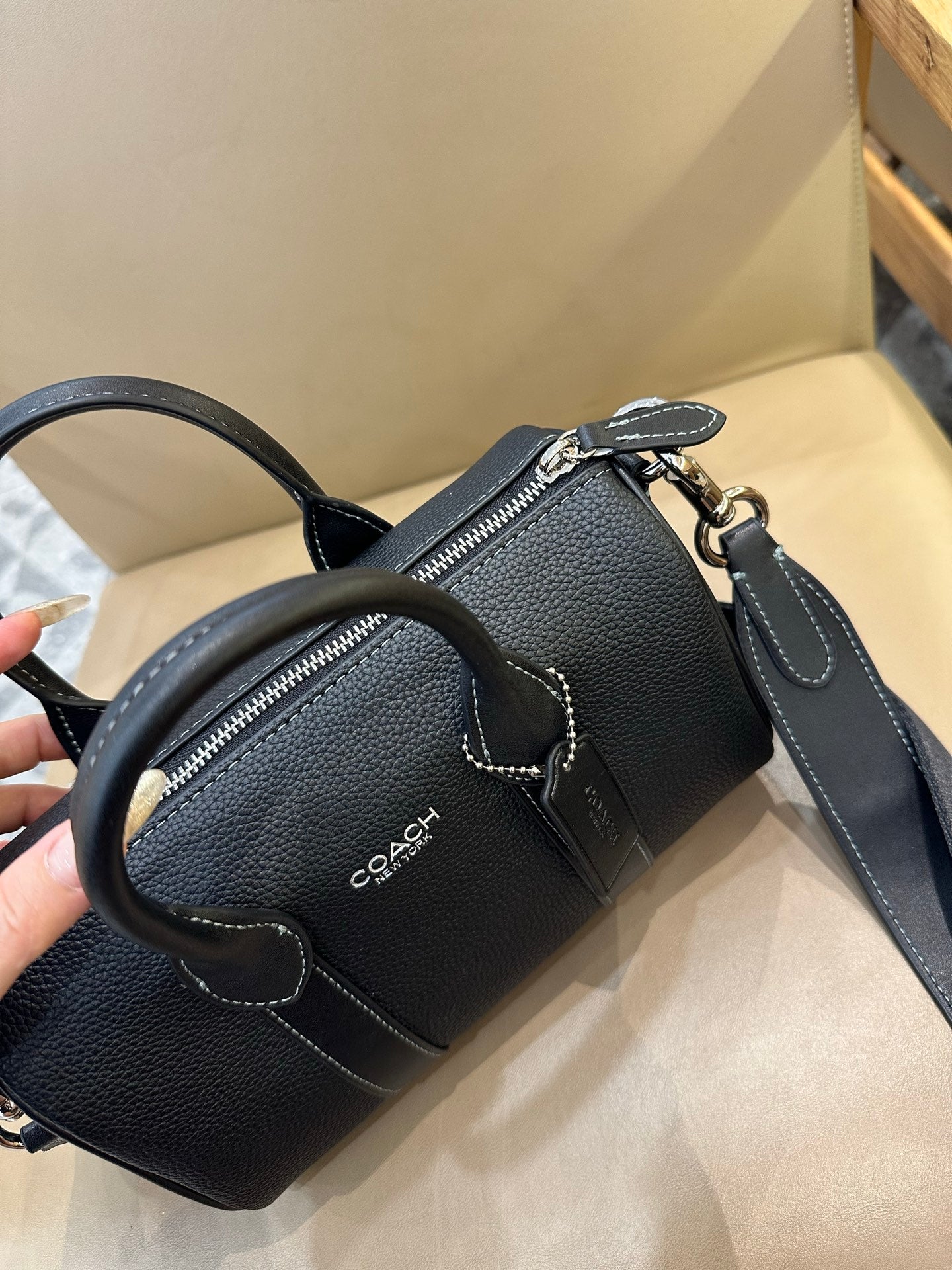 Coach leather mini duffle bag with two zip pockets and crossbody strap