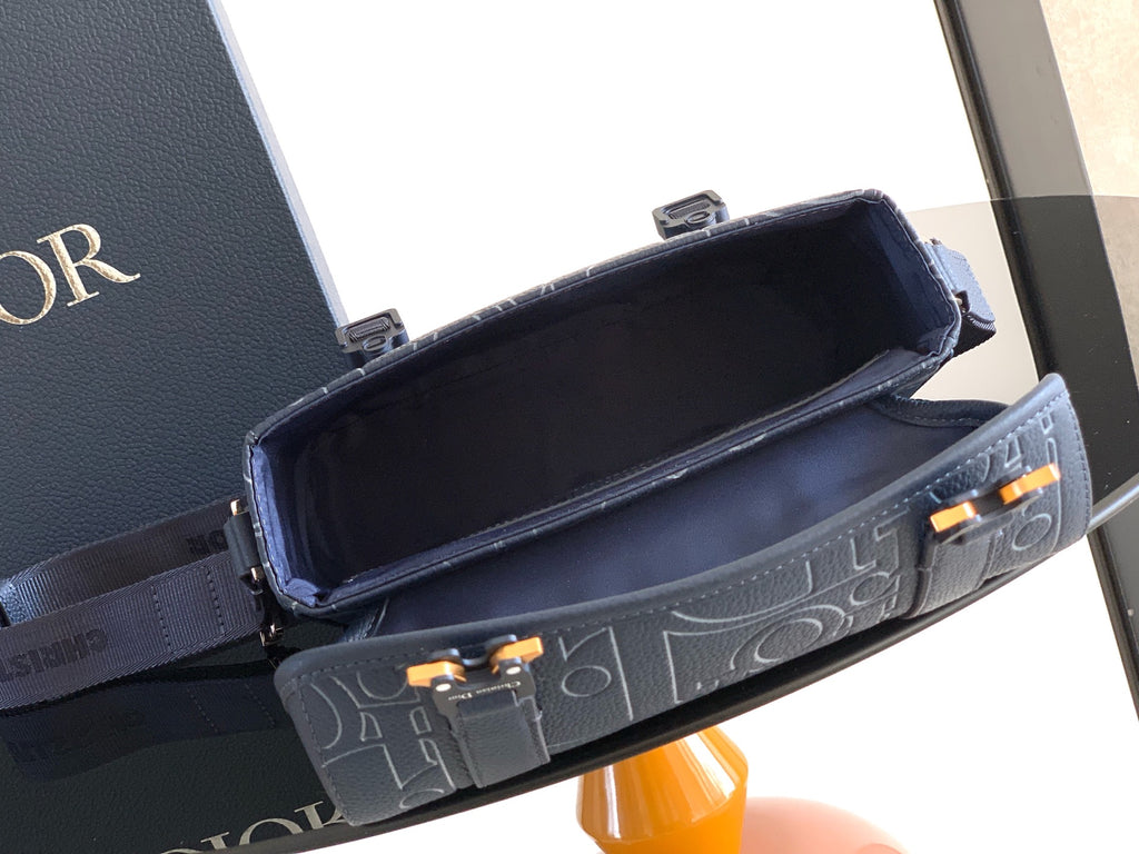 Dior blue embossed monogram bag open top with black interior lining and gold-tone hardware