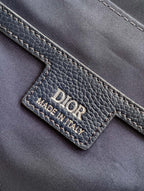 Dior blue leather bag close-up showing “DIOR” logo and “MADE IN ITALY” label