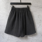 Balenciaga dark shorts on hanger with elastic waistband and pleated front
