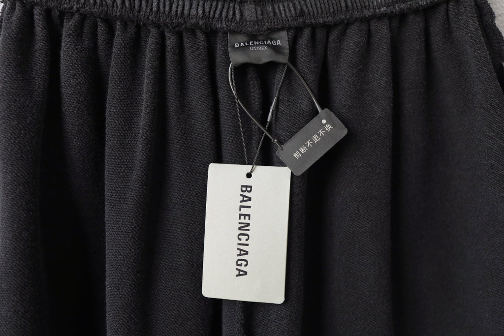 Balenciaga dark shorts with elastic waistband and attached hang tags