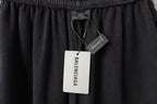 Balenciaga dark shorts with elastic waistband and attached hang tags