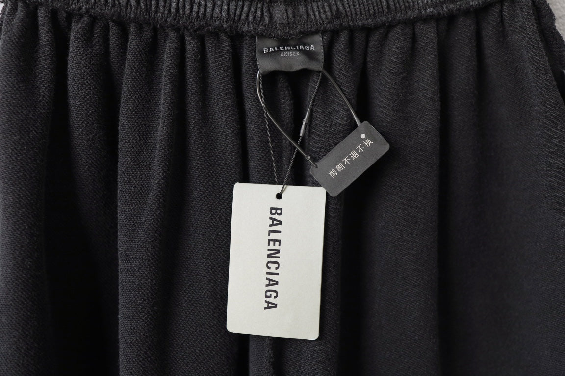 Balenciaga dark shorts with elastic waistband and attached hang tags