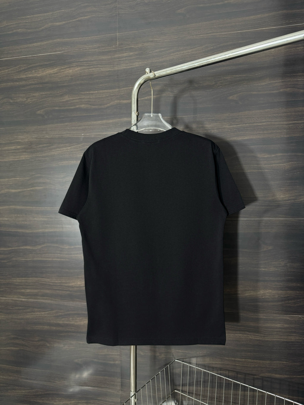 Black crewneck T-shirt, plain back view on a hanger.
