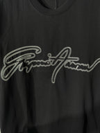 Black crewneck T-shirt with rhinestone script logo detail on the chest.