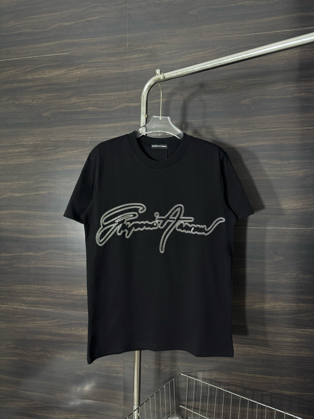 Black crewneck T-shirt with rhinestone script logo on the front.