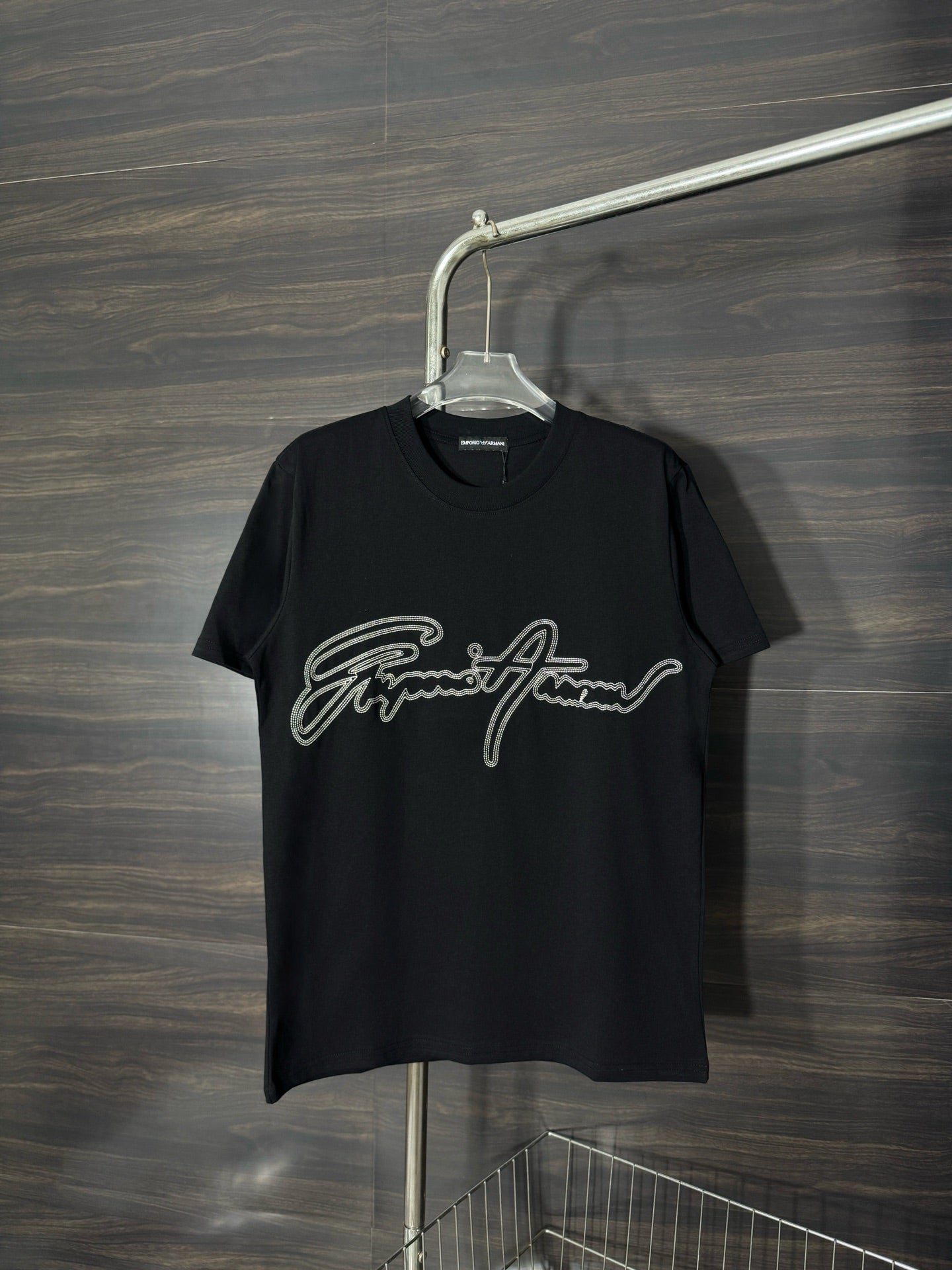Black crewneck T-shirt with rhinestone script logo on the front.