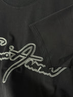 Black T-shirt with rhinestone script logo and side seam detail.