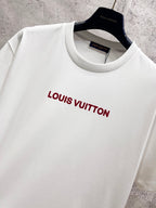 White crewneck short-sleeve T-shirt with red Louis Vuitton logo at center chest.