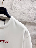 White crewneck short-sleeve T-shirt shoulder and neckline detail on hangers.