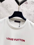 White crewneck short-sleeve T-shirt neckline view with Louis Vuitton logo on chest.