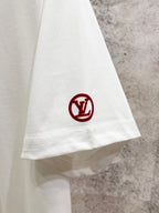 White T-shirt hem with red circular LV monogram patch.