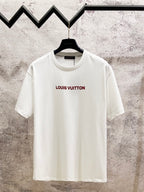 White crewneck short-sleeve T-shirt with red Louis Vuitton logo on chest.
