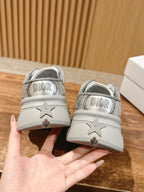 Back view of silver Dior sneakers with star detail on heel