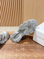 Outsole of silver Dior sneaker showing star pattern traction tread