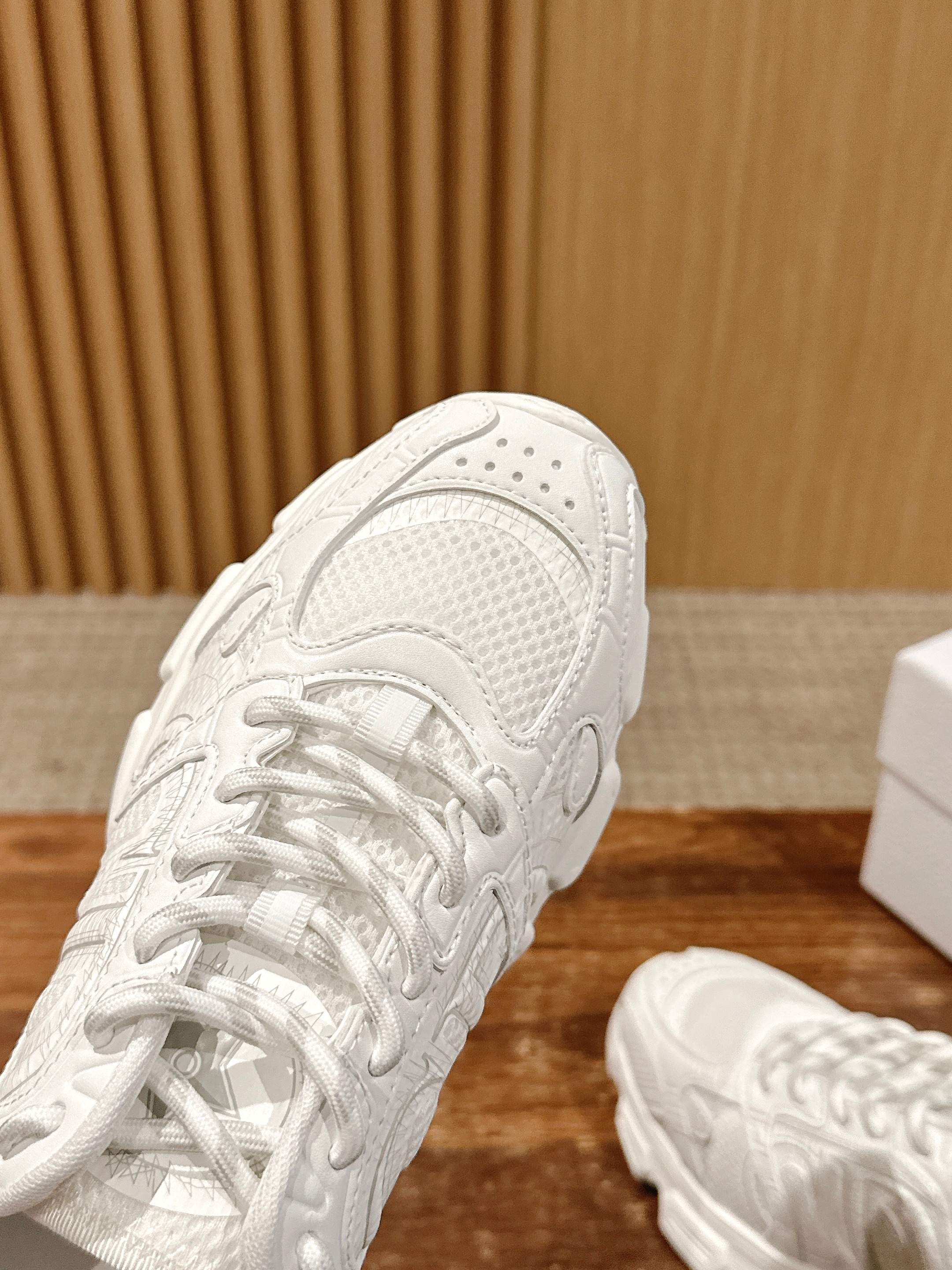 White Dior sneaker close-up on the upper, laces and perforated panel details