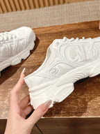 White Dior sneaker close-up, side panel texture and chunky sole profile