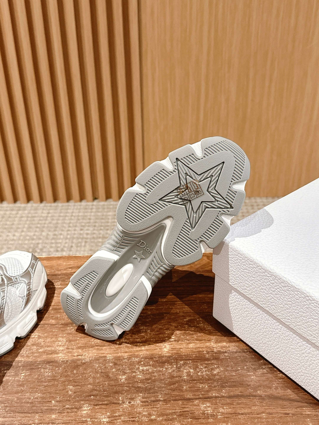 Outsole of a white Dior sneaker with star-pattern tread for grip