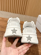 White Dior sneakers with star heel detail and DIOR text on back
