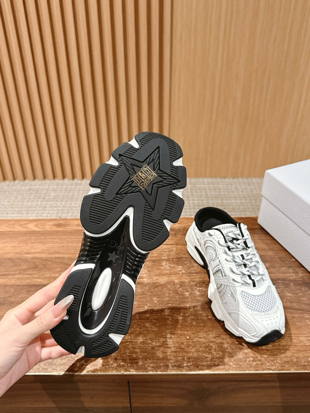 Pair view: black rubber outsole and white lace-up sneaker with black laces
