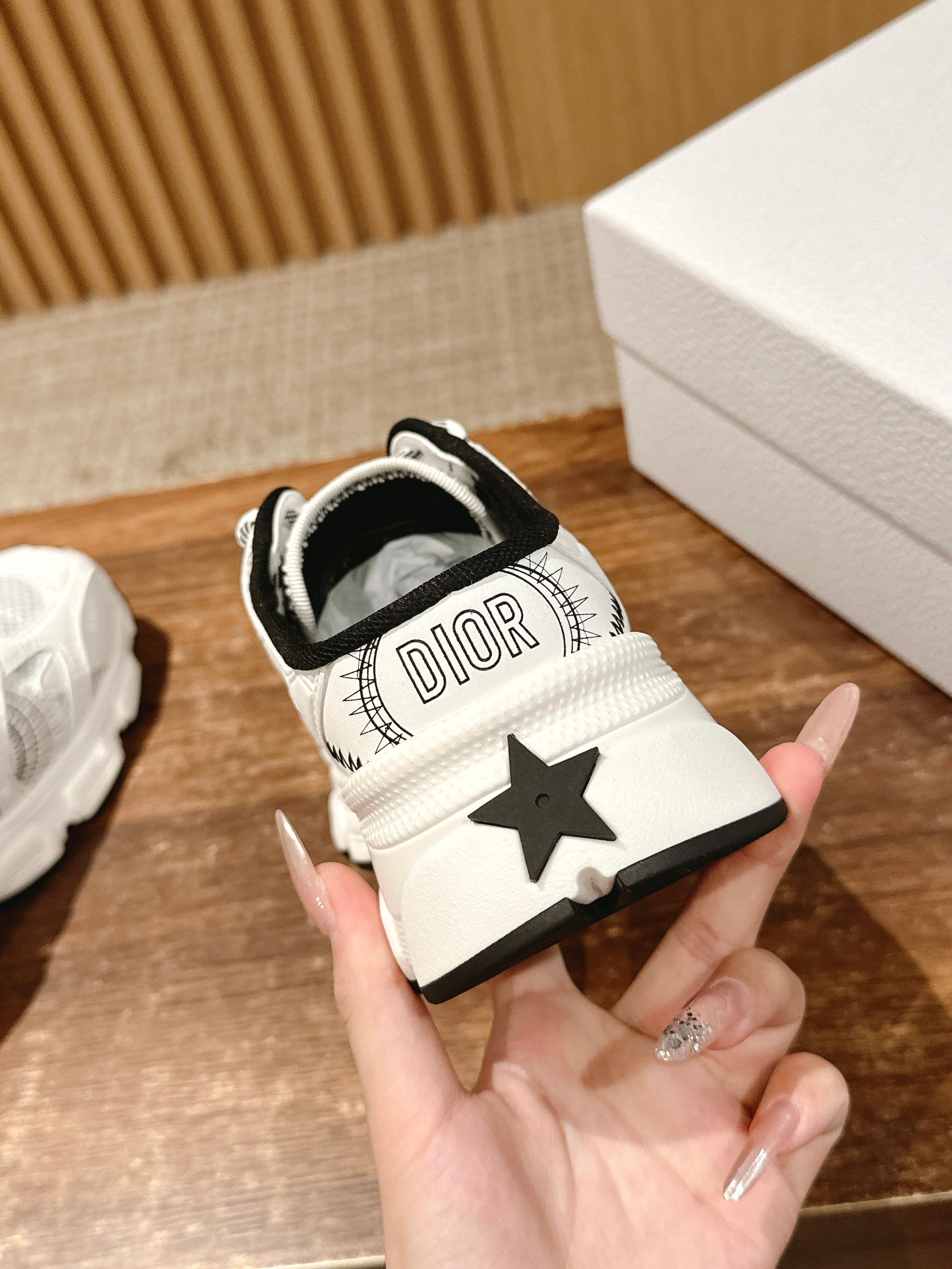 White sneaker with Dior text on heel tab and black star patch