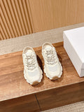 White lace-up sneakers with textured panels and padded collar