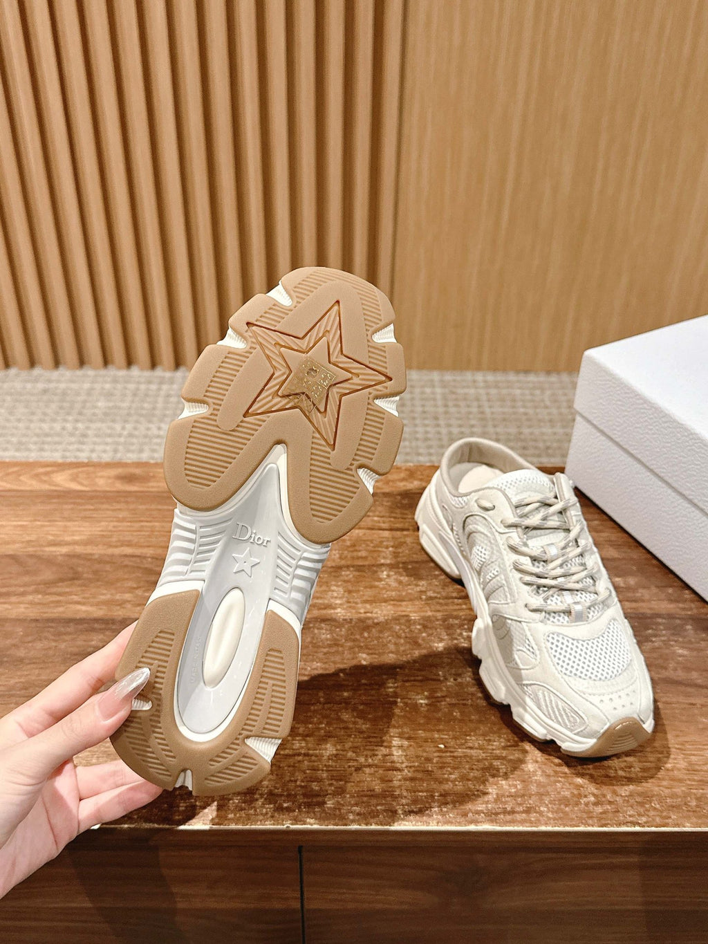 White sneaker outsole view with star tread detail and matching lace-up shoe