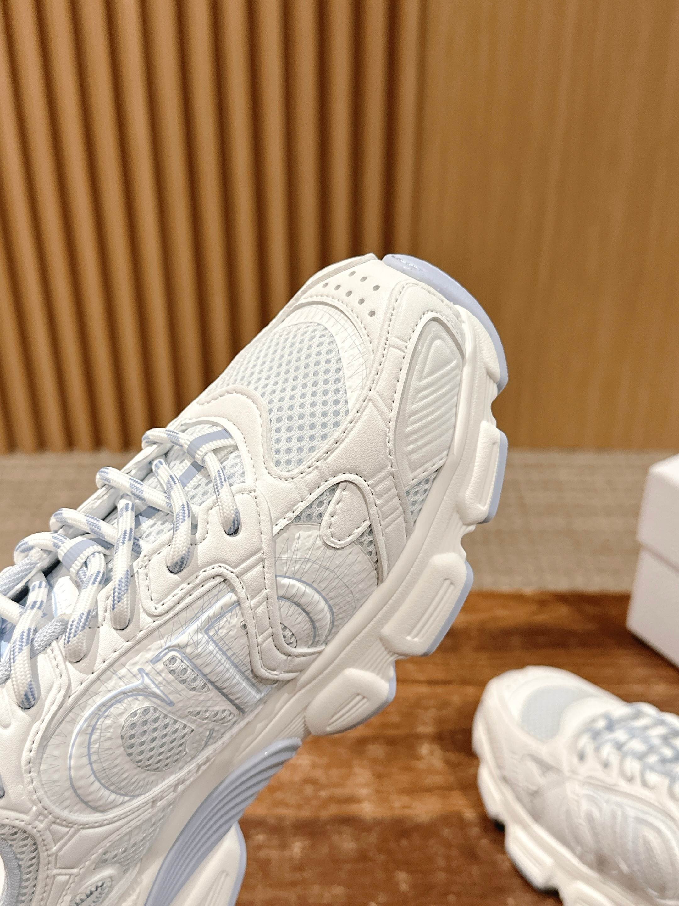 White Dior sneaker heel and side view, showing laces and cushioned sole