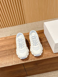 White Dior lace-up sneakers with mesh panels and textured rubber sole