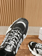 Dior lace-up sneaker close-up, black mesh and white panels with lace detail