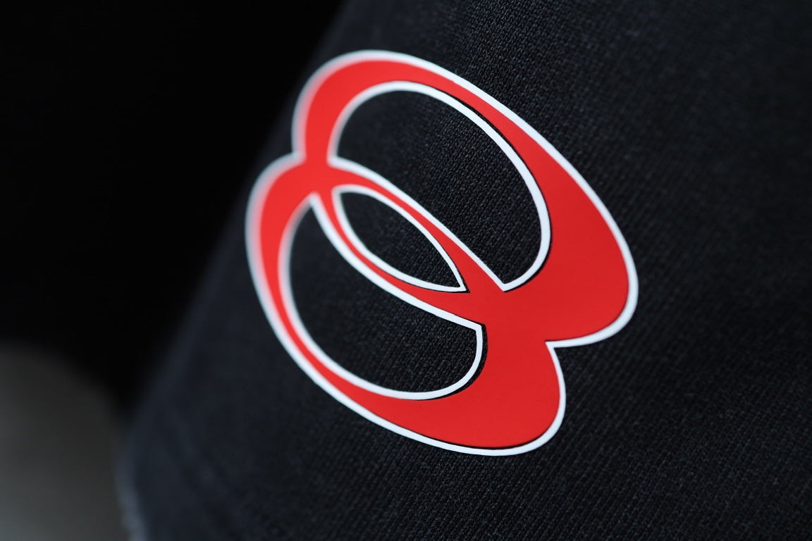 Red Balenciaga logo on black fabric