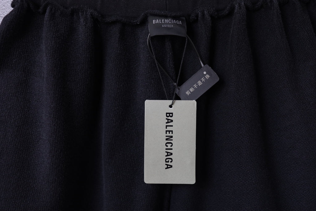 Black Balenciaga shorts with Balenciaga hang tags attached at the waistband
