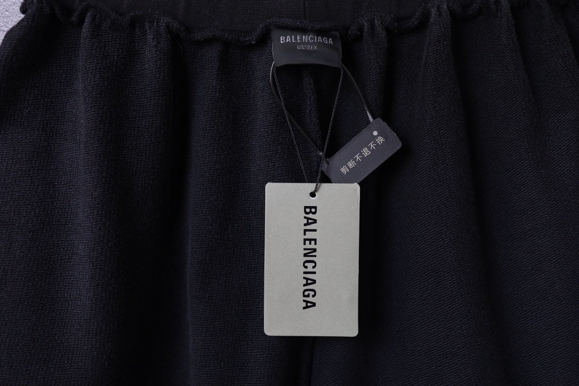 Black Balenciaga shorts with Balenciaga hang tags attached at the waistband