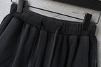 Black Balenciaga shorts with elastic waistband and drawstring, hanging on clips