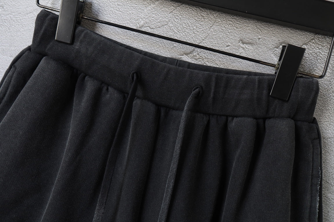 Black Balenciaga shorts with elastic waistband and drawstring, hanging on clips