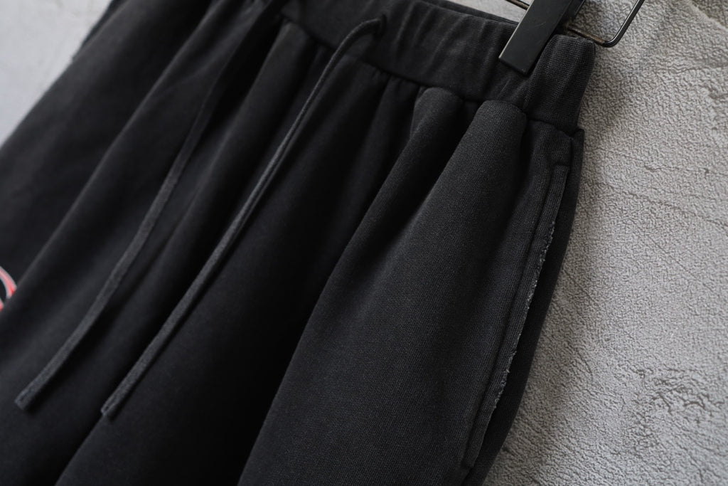 Black Balenciaga shorts with pleated front, elastic waistband, and drawstring