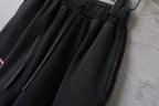 Black Balenciaga shorts with pleated front, elastic waistband, and drawstring