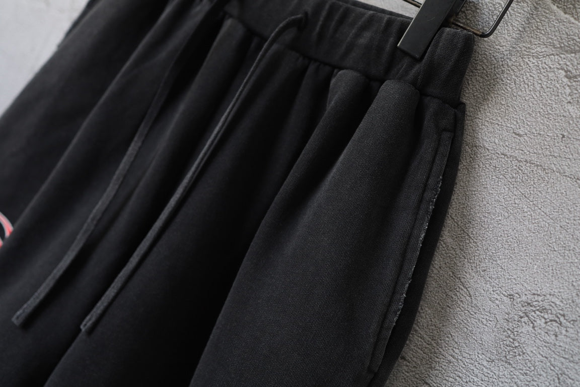 Black Balenciaga shorts with pleated front, elastic waistband, and drawstring