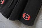 Black Balenciaga shorts with red logo print on the lower leg