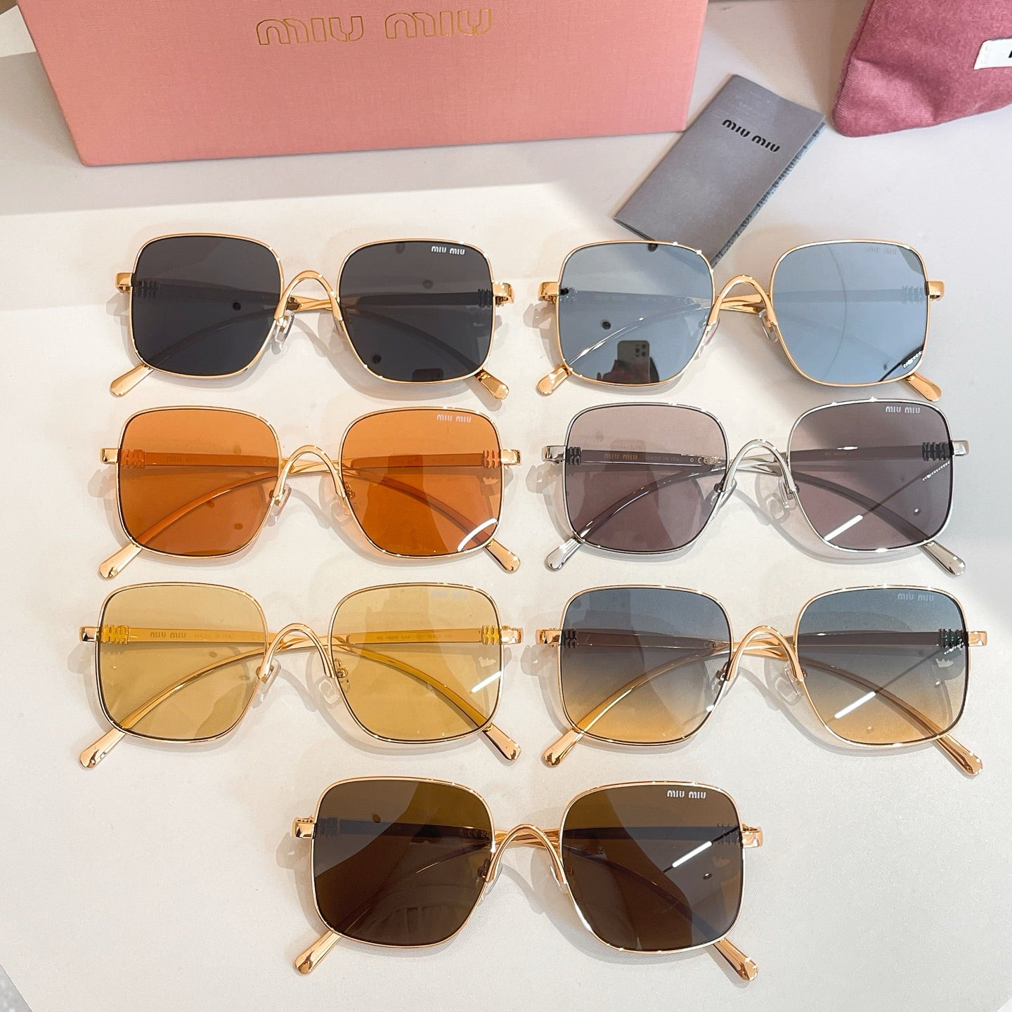 Assorted square sunglasses with gold and clear frames, multiple lens tints