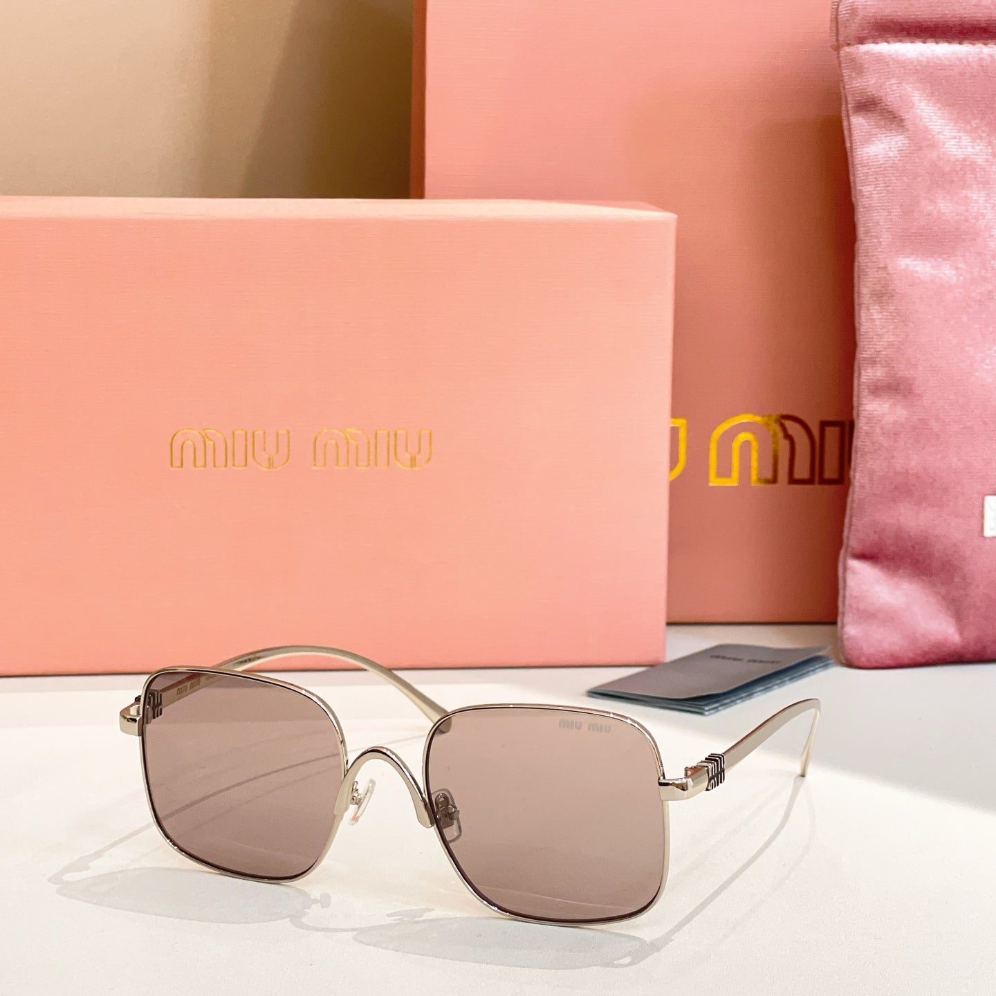 Silver-framed square sunglasses with taupe-tinted lenses