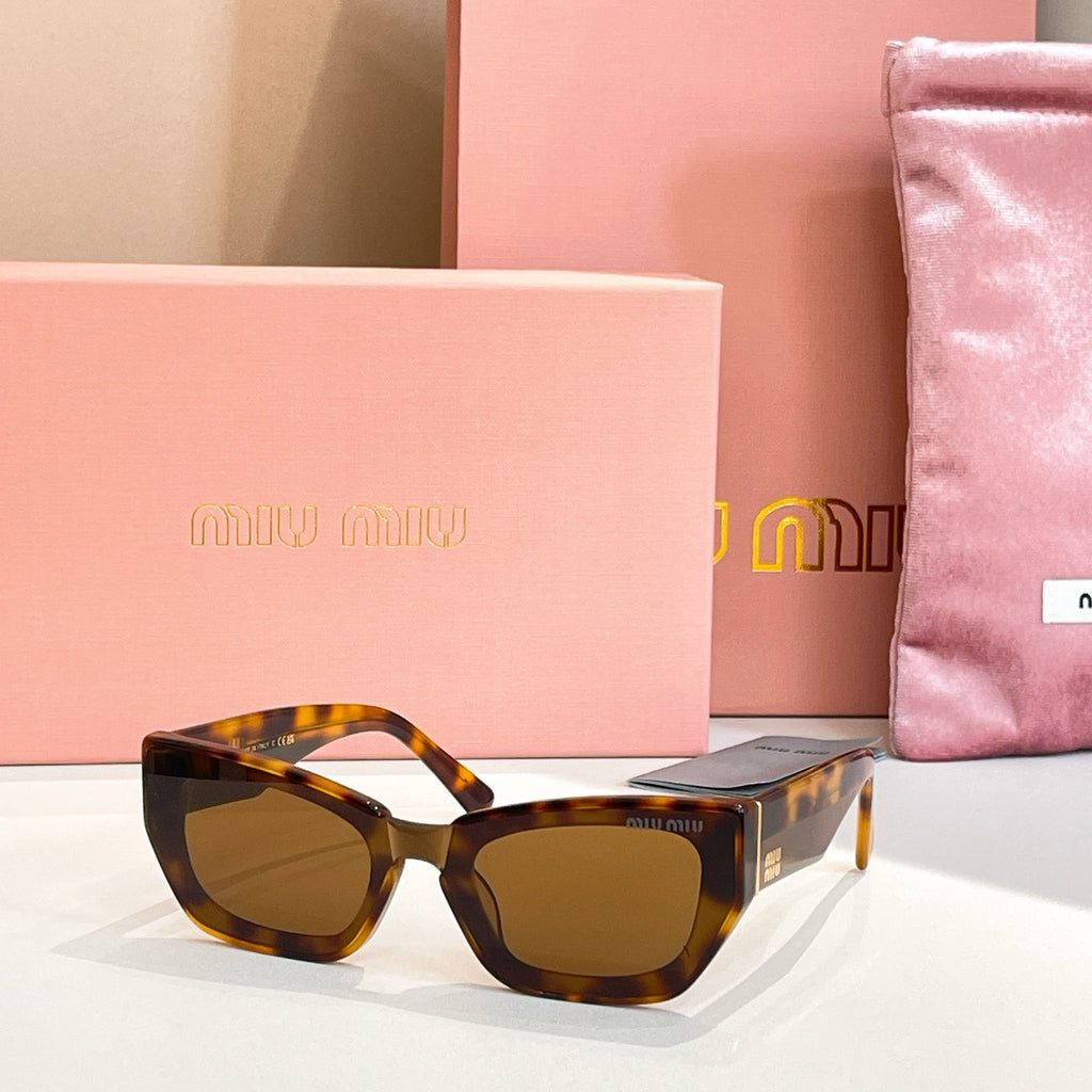 MiuMiu sunglasses with tortoiseshell frames and amber tinted lenses.