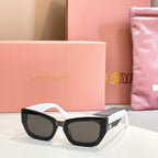 MiuMiu sunglasses with black frames and white arms, dark lenses.
