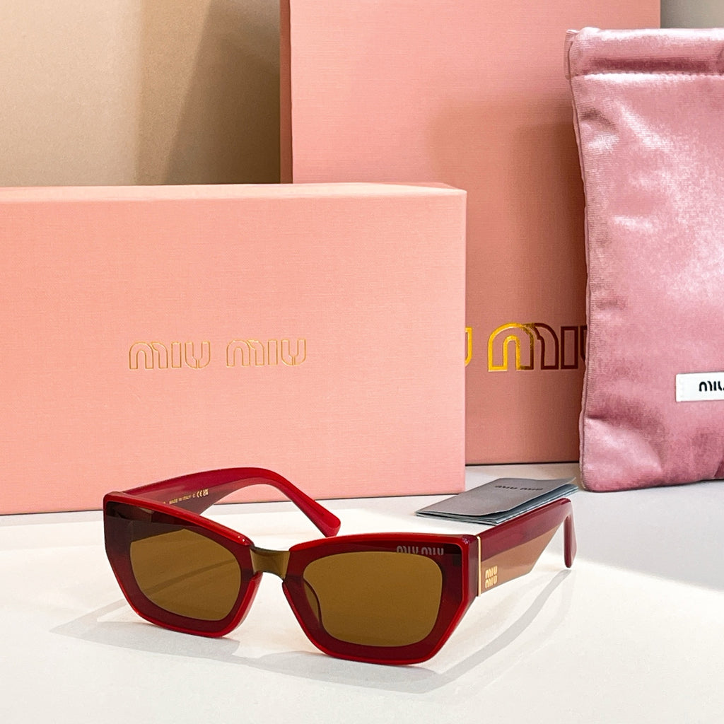 MiuMiu sunglasses with red frames and dark tinted lenses.